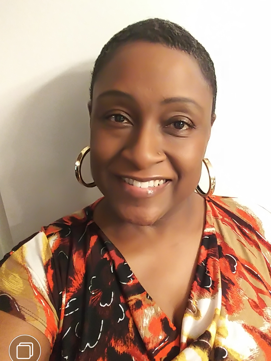 Black woman in multi-colored shirt